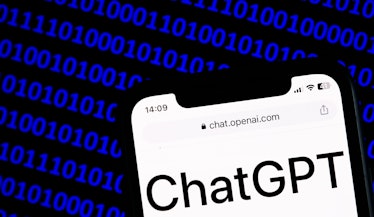 ChatGPT website displayed on a phone screen and a binary code displayed on a screen are seen in this...