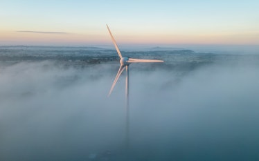 SHEPTON MALLET, UNITED KINGDOM - JANUARY 21: Early morning mist surrounds a wind turbine as the sun ...