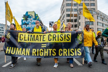 People hold an Amnesty International banner during a massive climate demonstration organ...