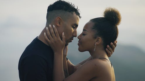 Heterosexual african ethnicity romantic couple loving and embracing under clear sky.