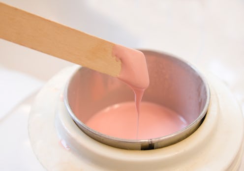 Wax on a stick ready to spread.