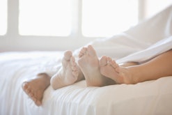 couple's feet tangled in sheets in article about dirty valentine's day puns