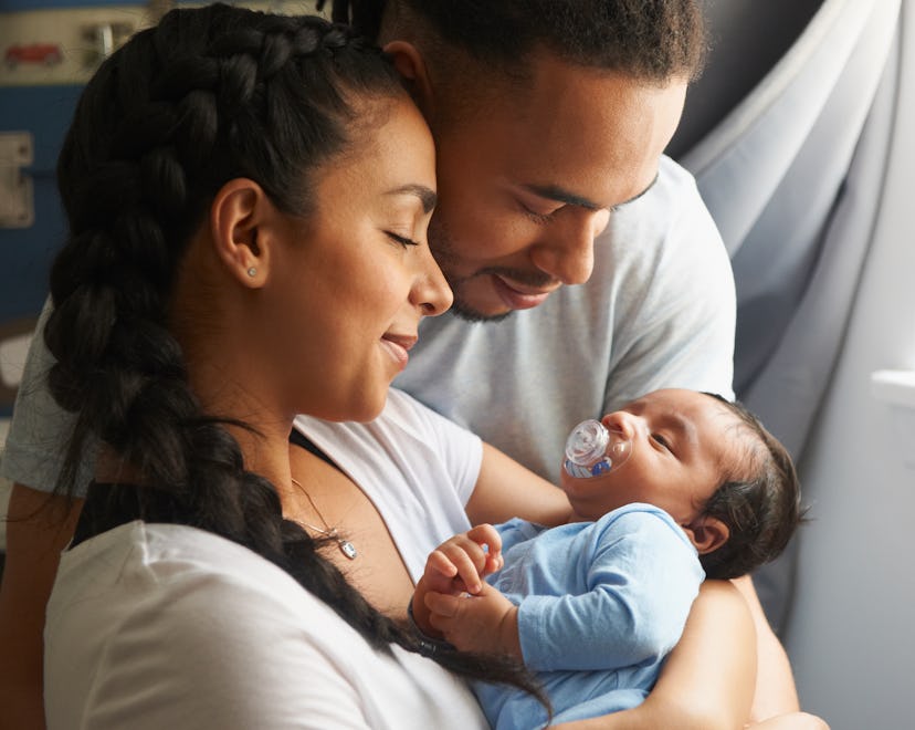 parents holding a baby born on friday the 13th