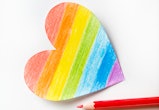 The heart is carved and drawn on white paper and painted in the color of the LGBT flag. There are Br...