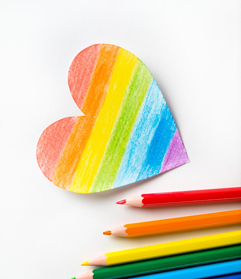 The heart is carved and drawn on white paper and painted in the color of the LGBT flag. There are Br...