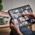 Detail of a mans hand scrolling through Netflix on an Apple iPad Pro, taken on March 6, 2020. (Photo...