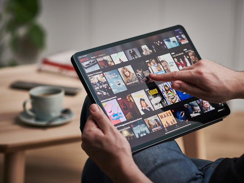 Detail of a mans hand scrolling through Netflix on an Apple iPad Pro, taken on March 6, 2020. (Photo...