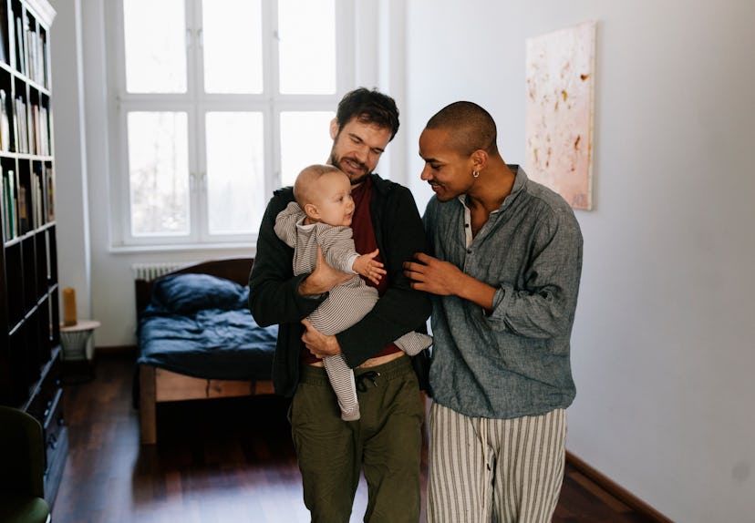 Fathers leaving room together carrying newborn son, in a story about questions to ask your partner a...
