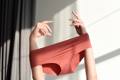 Seamless female panties in the hands of the girl in article about why vagina might be itchy