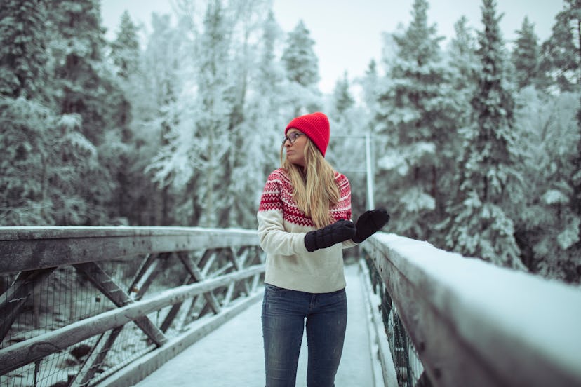 The female tourist enjoys hiking, visiting mountains, bridges, and rivers