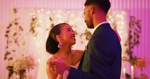 Cropped shot of a happy newlywed couple dancing together at their reception dinner after their weddi...