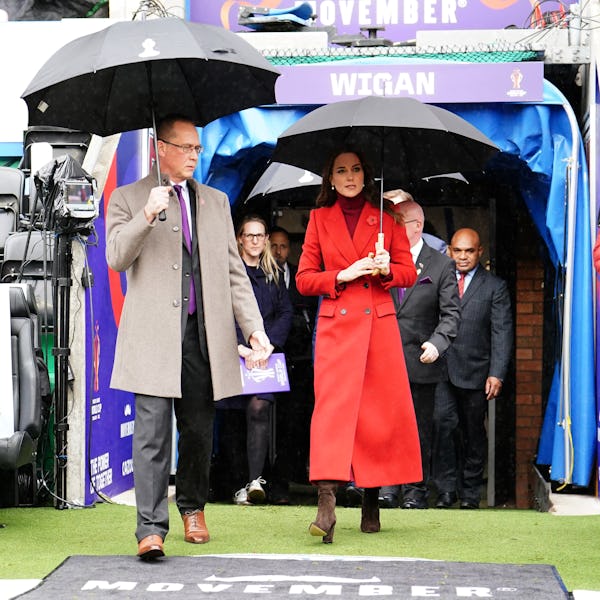 Kate Middleton wearing a custom red coat by Alexander McQueen.