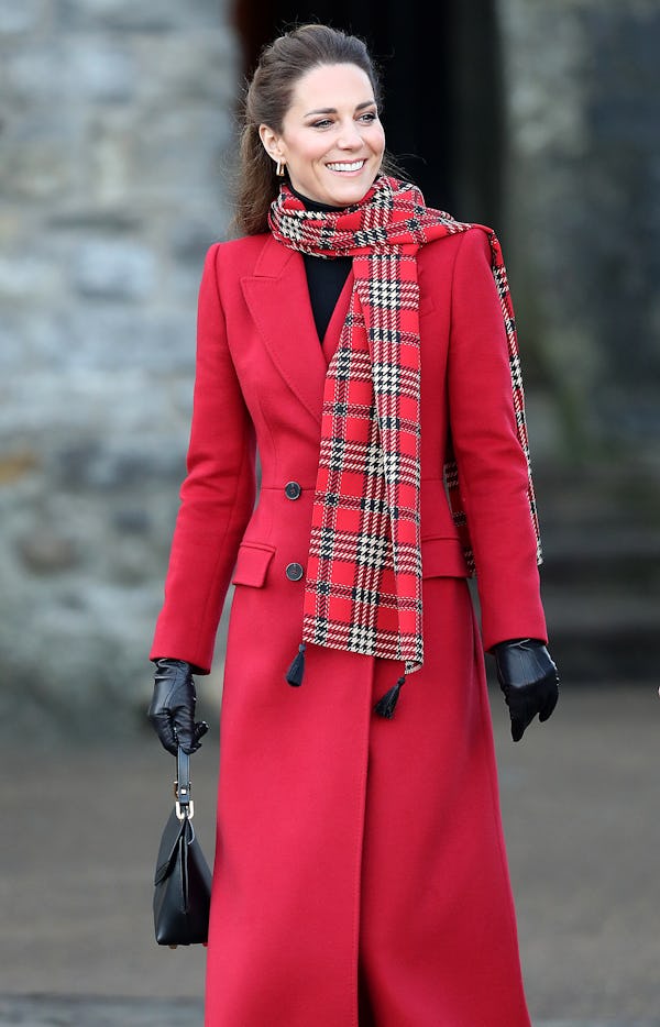 Kate Middleton wearing a custom red coat by Alexander McQueen.