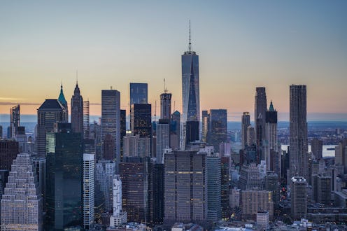 This aerial view from a helicopter over the East River looks west toward the tall towers of Lower Ma...