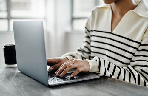 Laptop, hands typing and woman in home office writing report, email or social media content at desk....