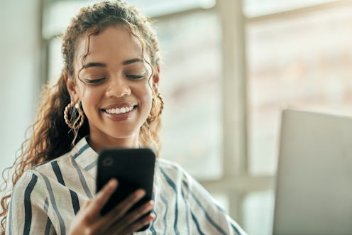 Phone, smile and business woman with mobile connection and texting in a office with happiness. Happy...