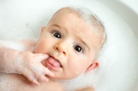 a baby in the bath, in an article about how to get rid of cradle cap treatments