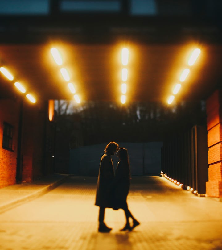 Couple kisses at night in a lit tunnel, and could potentially be in a karmic relationship