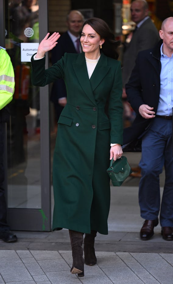 Kate Middleton wearing a custom green coat by Alexander McQueen.
