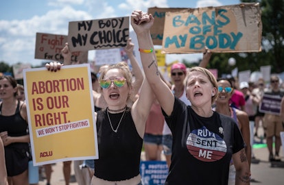 ST. PAUL, MN. - JULY 2022: McKayla Wolff left and Karen Wolff, joined hands as they rallied for abor...