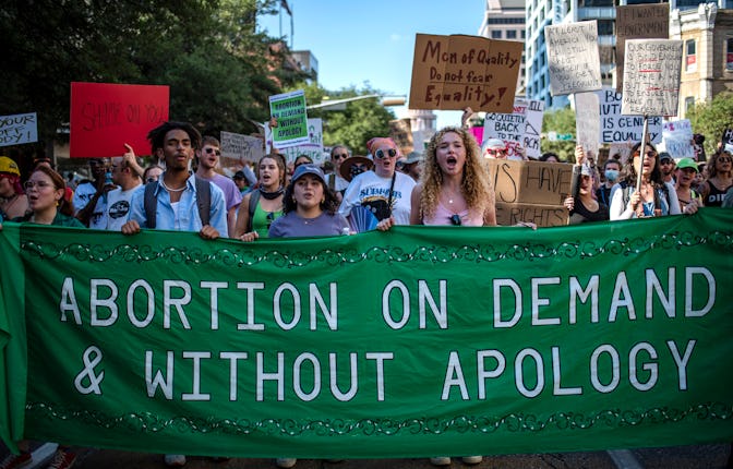 AUSTIN, TX -JUNE 25: Protesters march while holding signs during an abortion-rights rally on June 25...