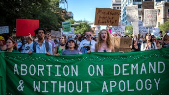 AUSTIN, TX -JUNE 25: Protesters march while holding signs during an abortion-rights rally on June 25...