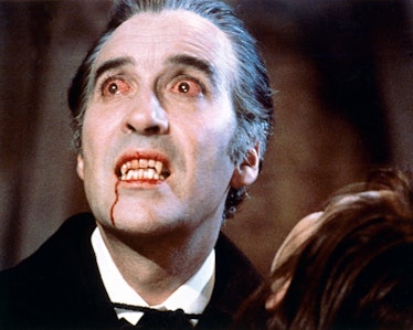 Christopher Lee, British actor, with bloodshot eyes and wearing pale facepaint and vampire's fangs i...
