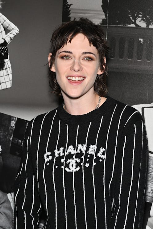 Kristen Stewart wearing a striped Chanel logo sweater.