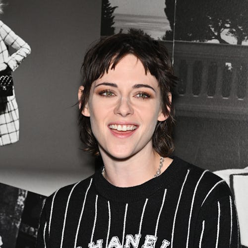 Kristen Stewart wearing a striped Chanel logo sweater.