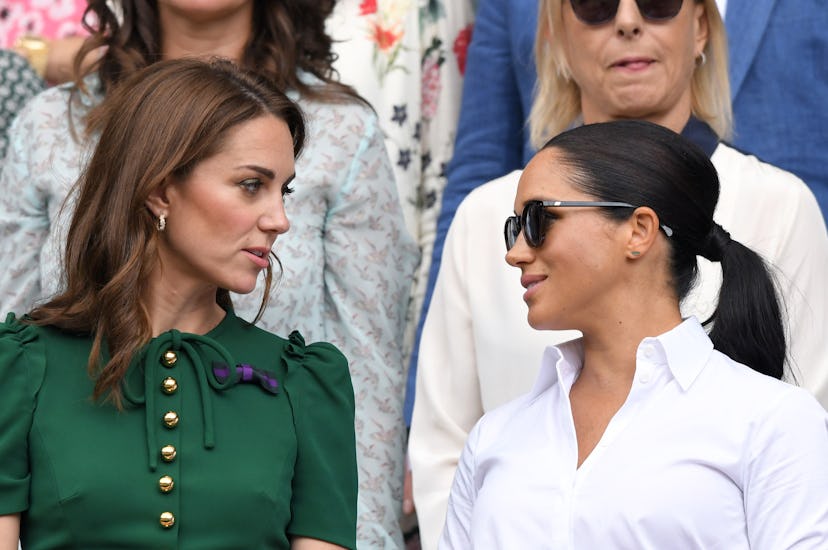 Catherine, Duchess of Cambridge and Meghan, Duchess of Sussex in the Royal Box on Centre Court at Wi...