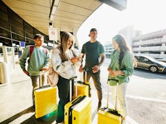 A family waits outside the airport for their Uber, using their free Uber voucher from booking a JetB...