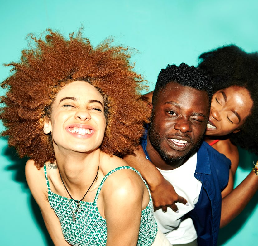 Three friends laugh and pose for a brightly lit photo as they consider how the January 2023 full moo...