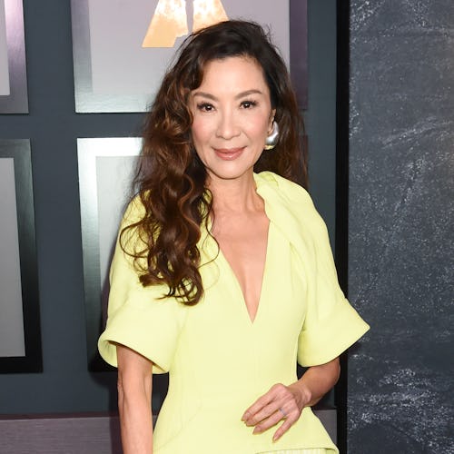 Michelle Yeoh wearing a yellow dress from Bottega Veneta.