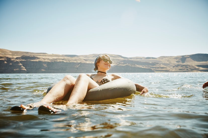 Young woman floating on an inner tube, in a story answering the question, can you go tubing while pr...