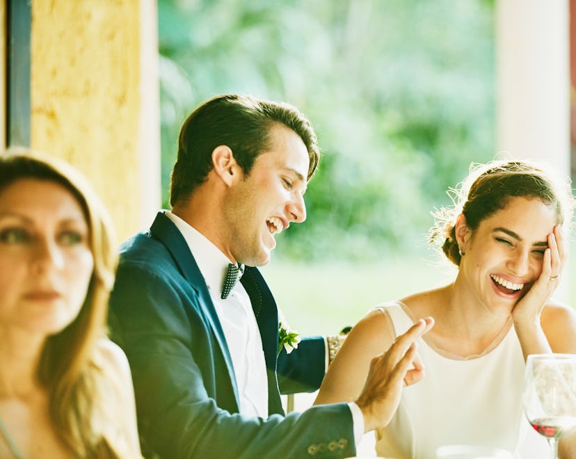 laughing bride and groom in article for newlywed game questions