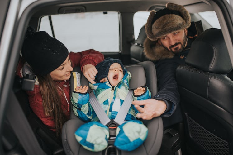 a young married couple with a child cares about safe driving
