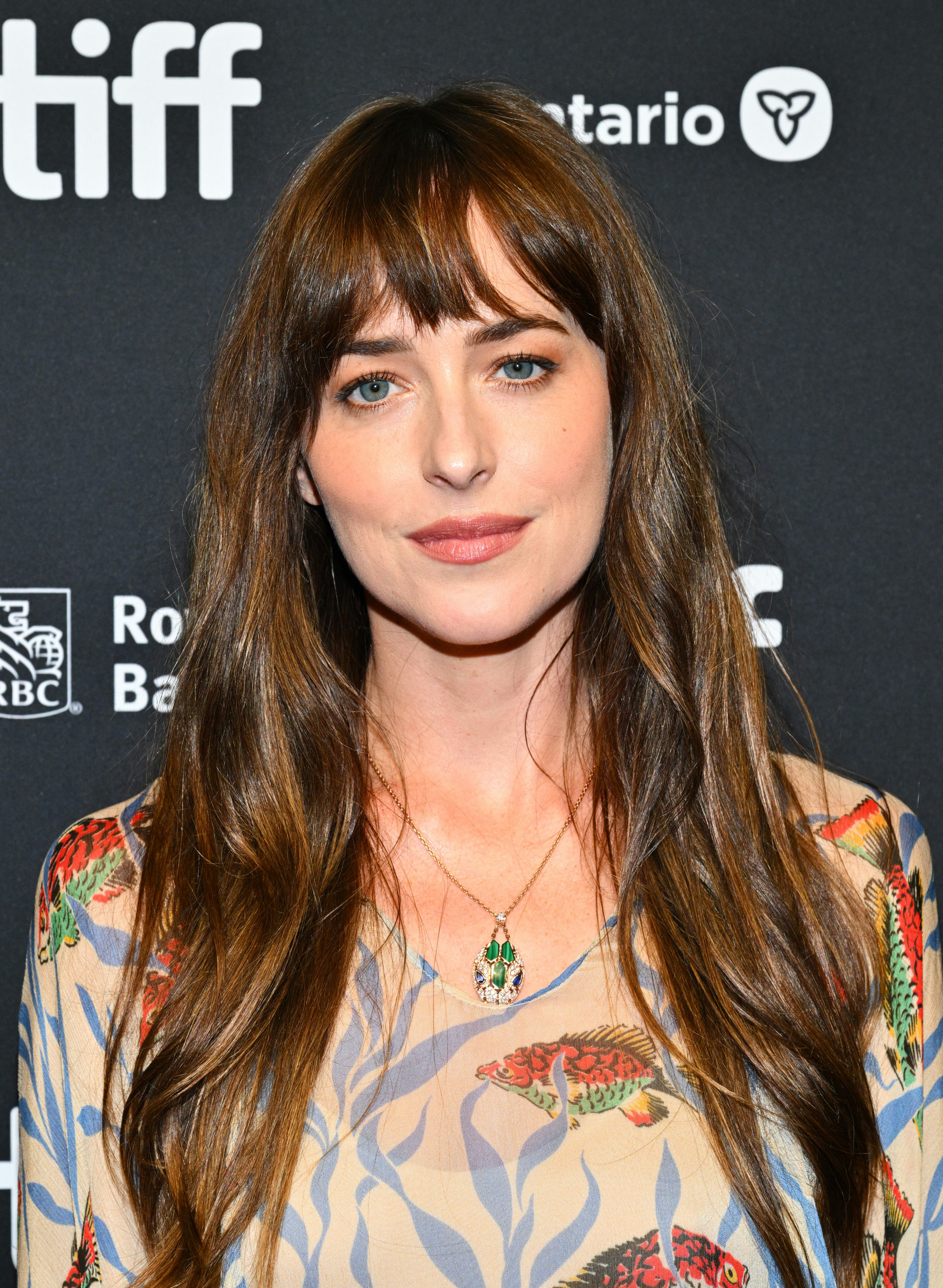Dakota Johnson with candlelit brunette hair.