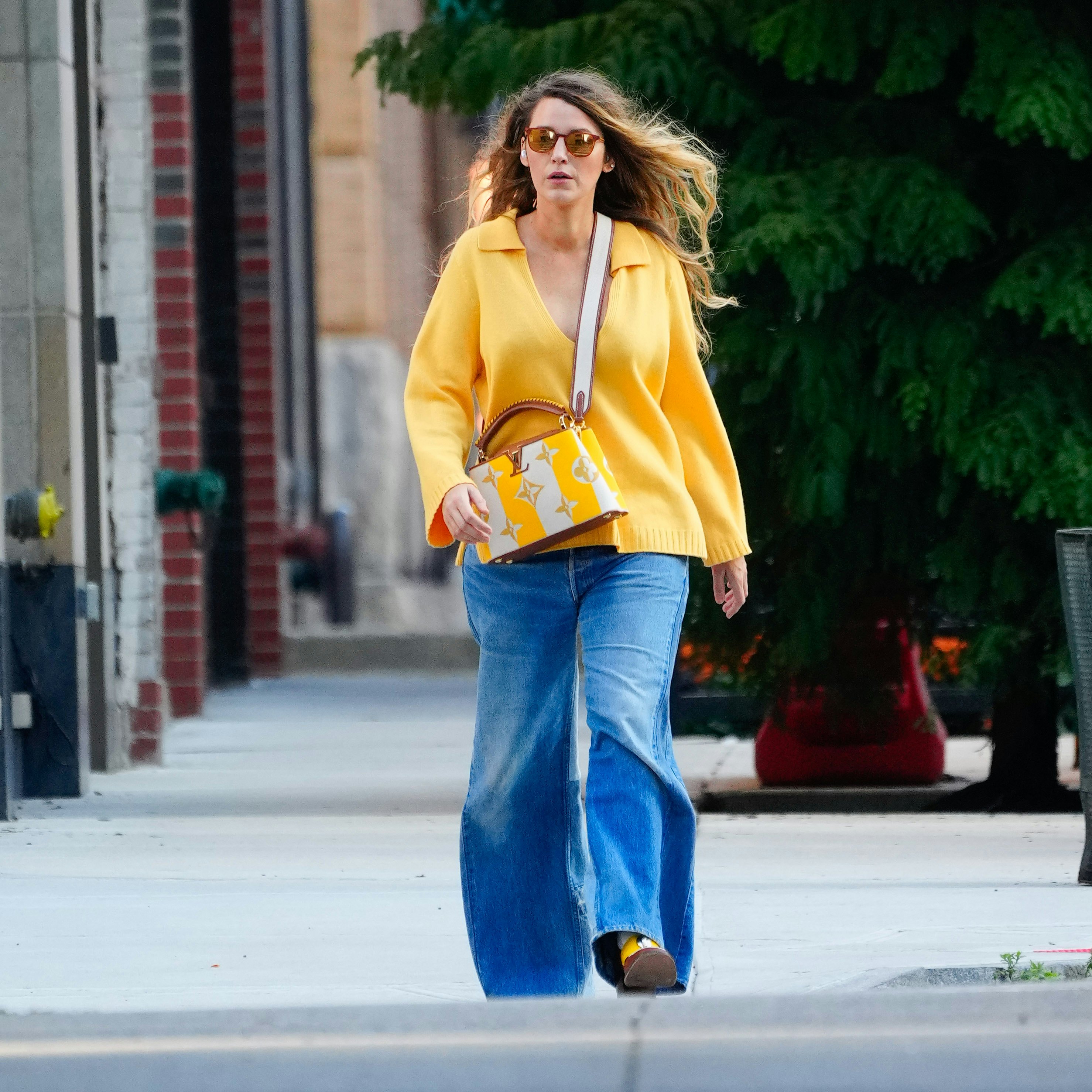 Blake Lively ditches her usual glamorous look as she bundles up in cardigan  sweater and 70s-style bell bottom jeans in chilly New York City