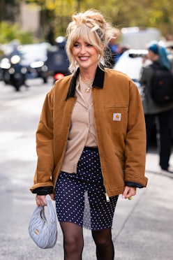 sheer fashion trend Emili Sindlev wears a beige top and cardigan, blue polka dot mini skirt, brown C...