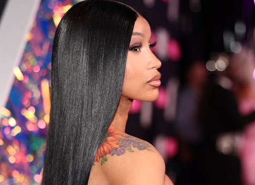 Cardi B celebrated her 31st birthday with a big curly updo and long bedazzled acrylic nails.