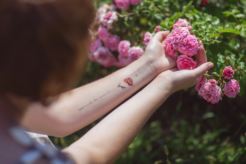 Flower and script tattoo, in a story about played out tattoo designs tattoo artists are tired of.