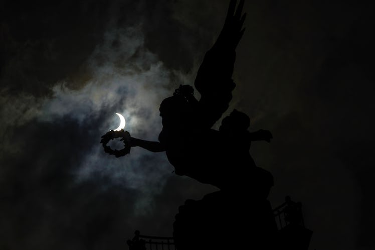 View of the solar eclipse in its maximum phase at the Angel of Independence in Mexico City 2023. (Ph...