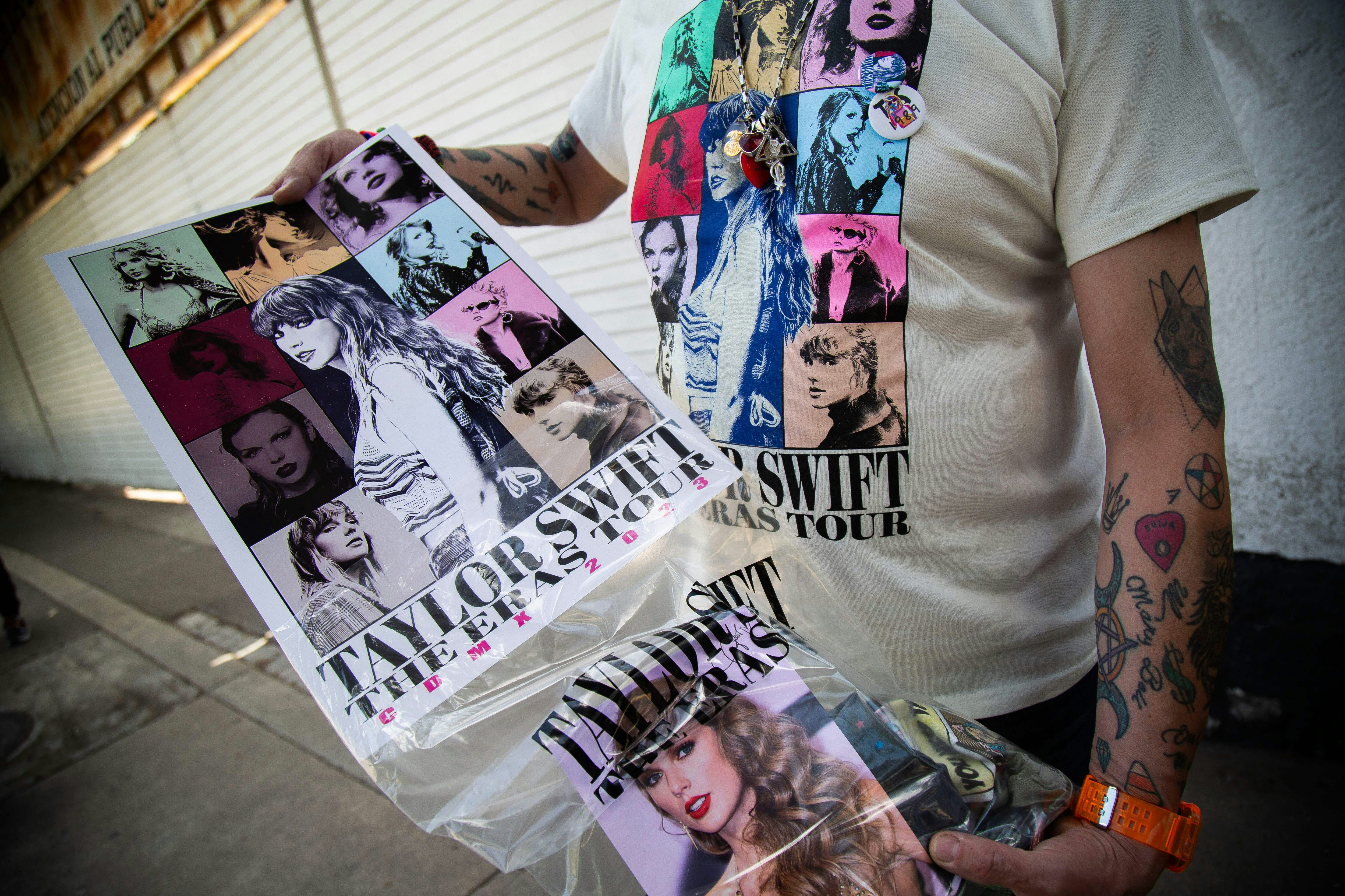A fan shows a poster with the image of US superstar Taylor Swift before her presentation at the Foro&hellip;