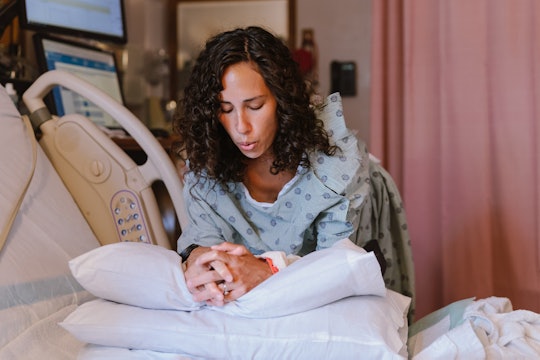 A pregnant woman leans against pillows and breathes through contractions, reciting birth affirmation...