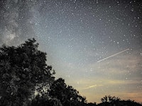 This photograph taken on August 14, 2023 in Fontainebleau, southern Paris, shows a view of the sky w...