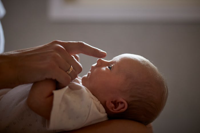 closeup of newborn profile in article about the accuracy of pulse ox baby monitors