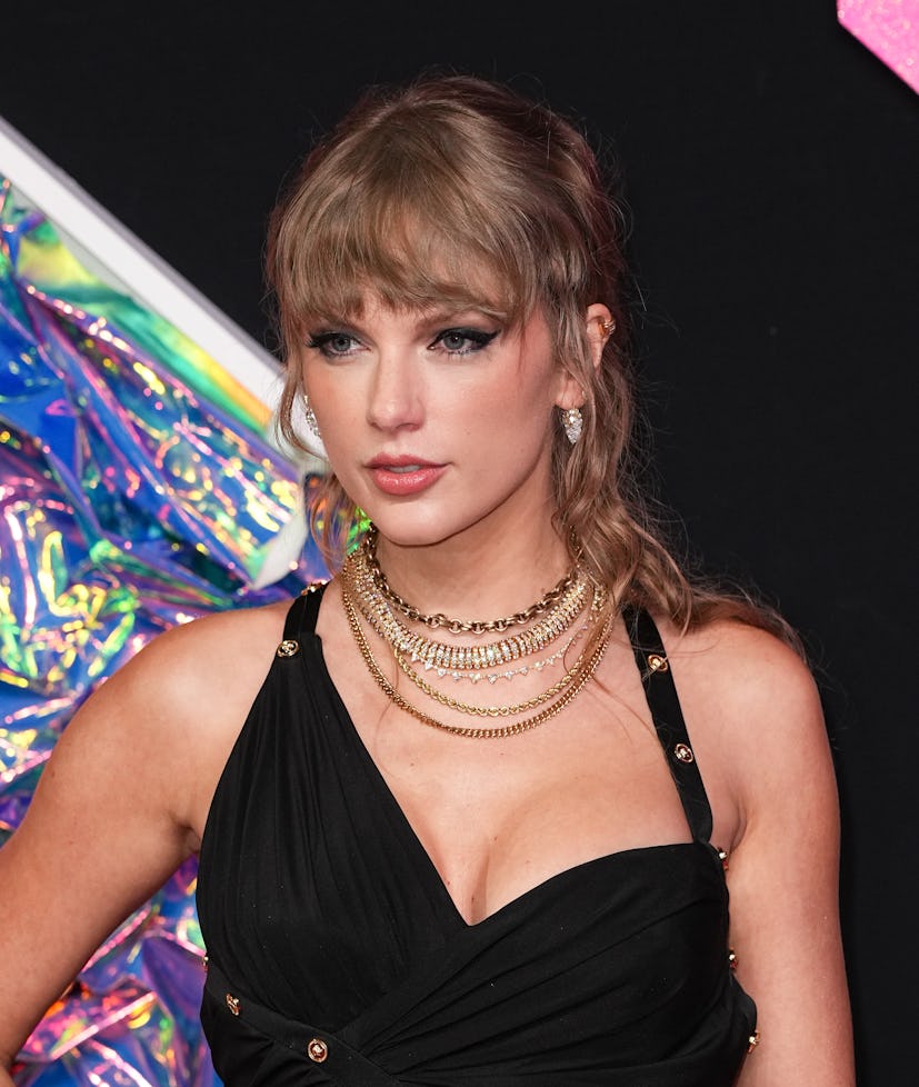 Taylor Swift wore a wavy, half-up hairstyle with textured bangs at the 2023 MTV Music Video Awards.