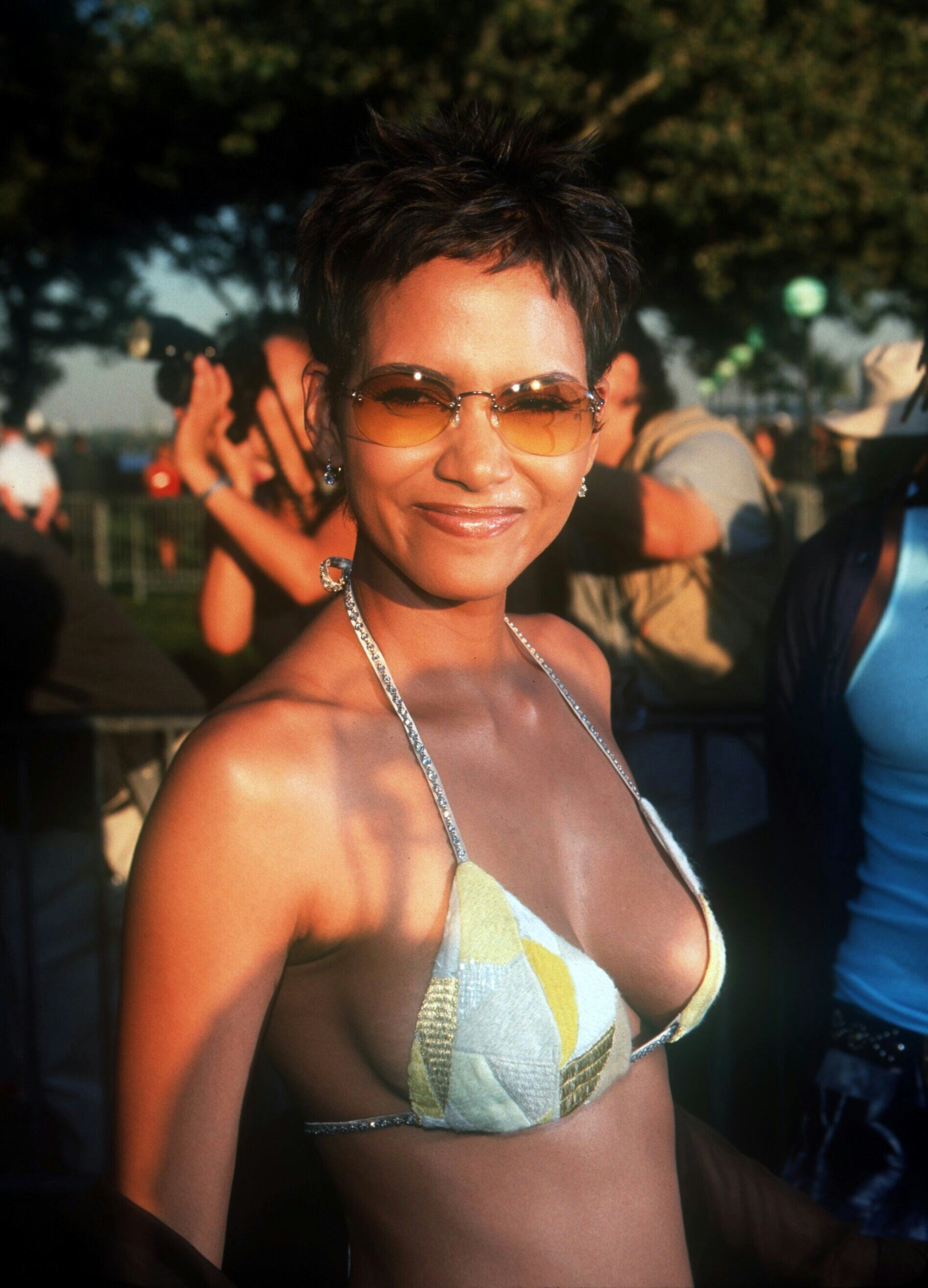 Halle Berry attends the X-Men premiere in a bikini top, low-rise pants, and belt.