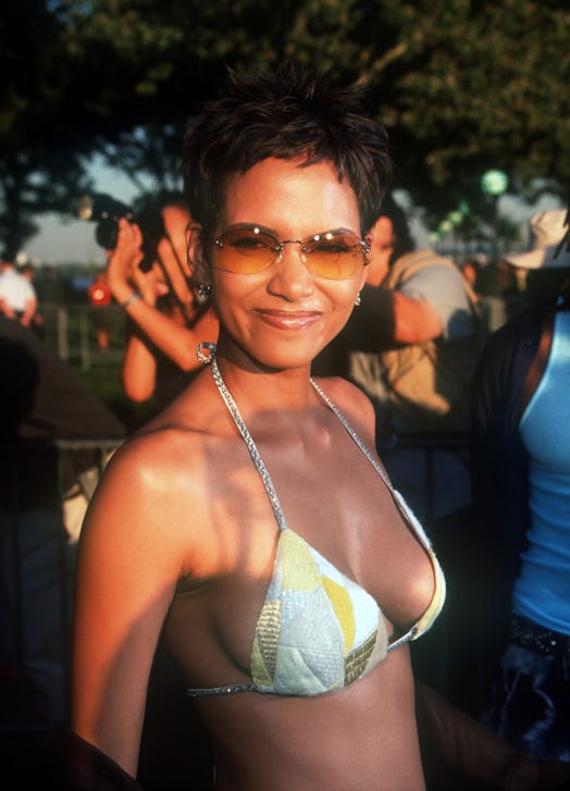 Halle Berry attends the X-Men premiere in a bikini top, low-rise pants, and belt. 