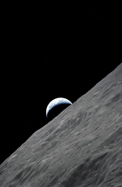 (7-19 Dec. 1972) --- The crescent Earth rises above the lunar horizon in this spectacular photograph...